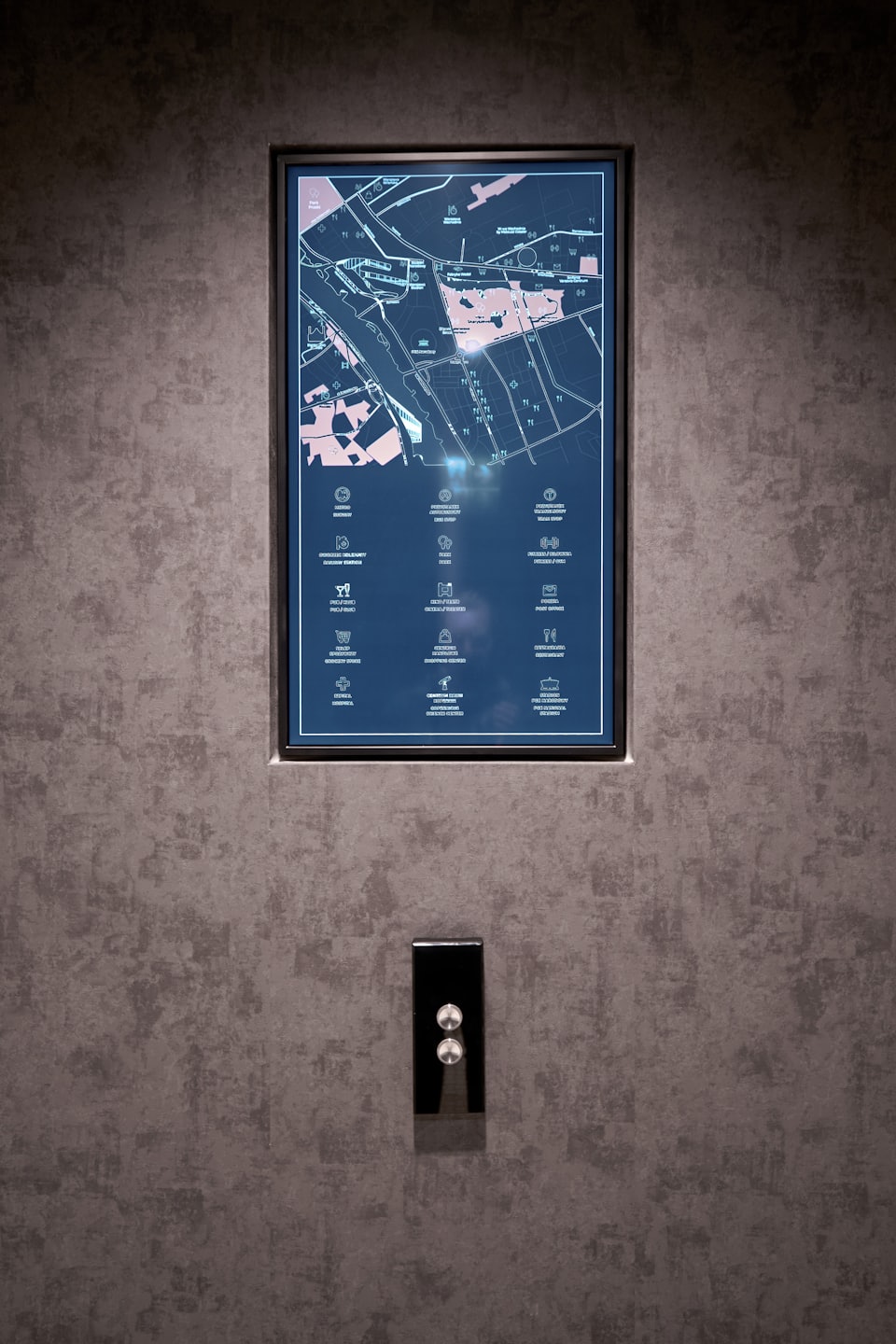 Digital directory map mounted on a dark textured wall.