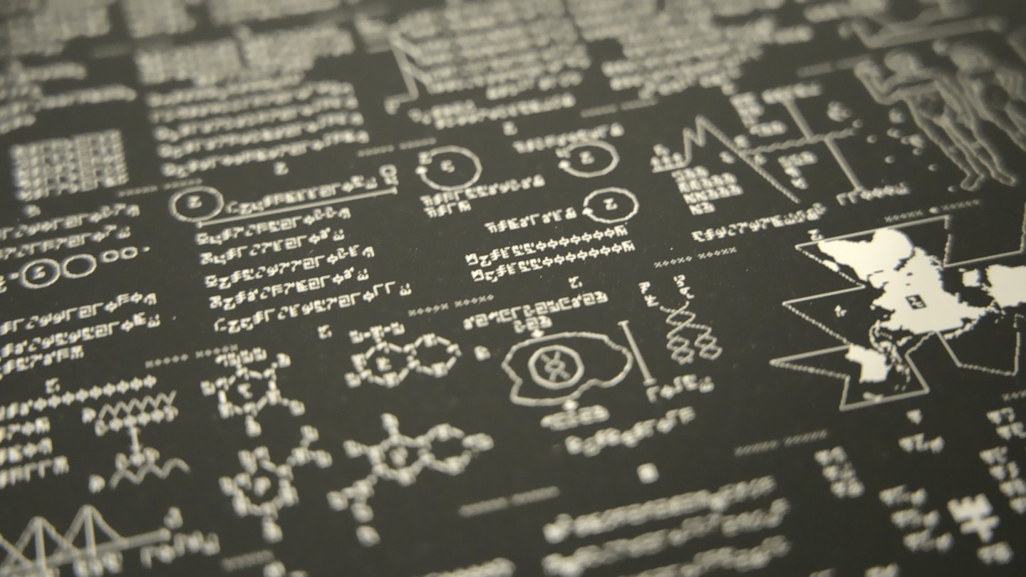Black surface covered with white scientific diagrams and symbols.